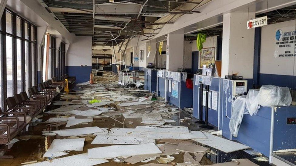 Debris is photograph scattered over airport counters and floor