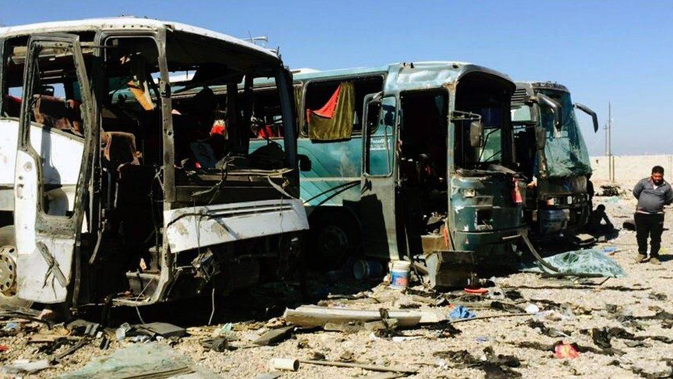 Burnt-out buses at the scene of a suicide blast in Samarra on 6 November 2016