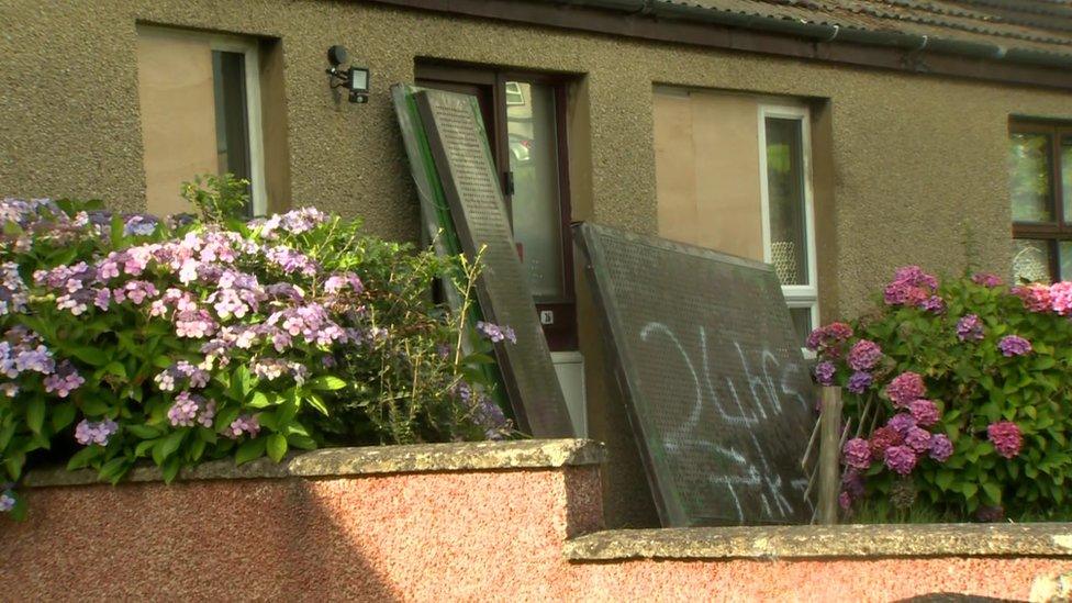 The house where petrol bomb was thrown at showing windows boarded up