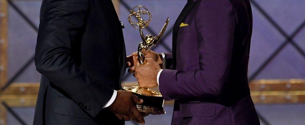 Donald Glover (R) accepts the Outstanding Directing for a Comedy Series Emmy award in 2017