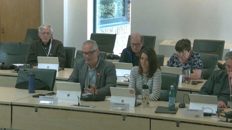 Five councillors in a meeting room