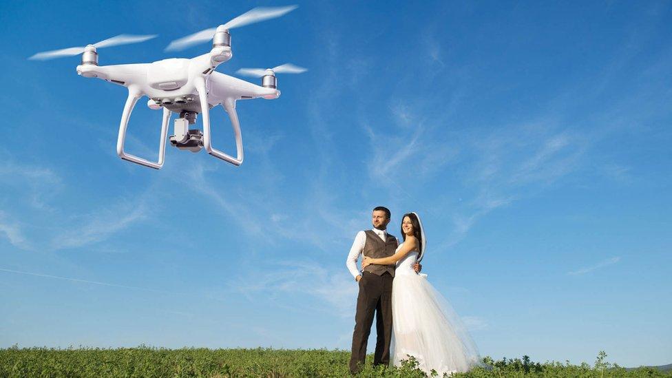 Drone photographing married couple