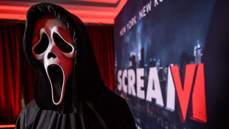 Actor dressed as Ghostface from the Scream film franchise