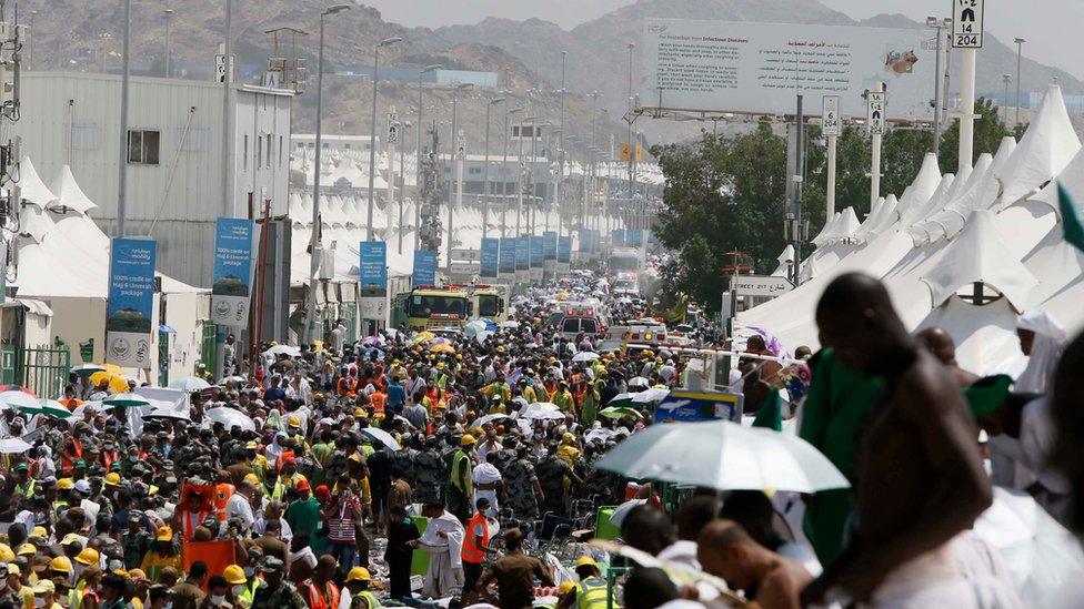 Muslim pilgrims and rescuers gather around the victims of a stampede in Mina, Saudi Arabia during the annual hajj pilgrimage on Thursday, Sept. 24, 2015.