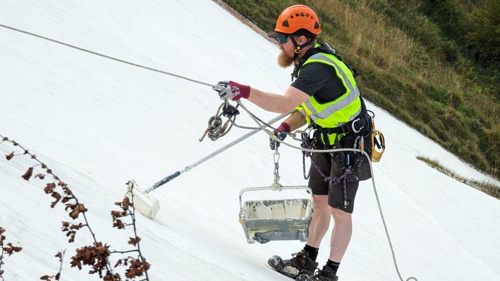 A man painting the White Horse