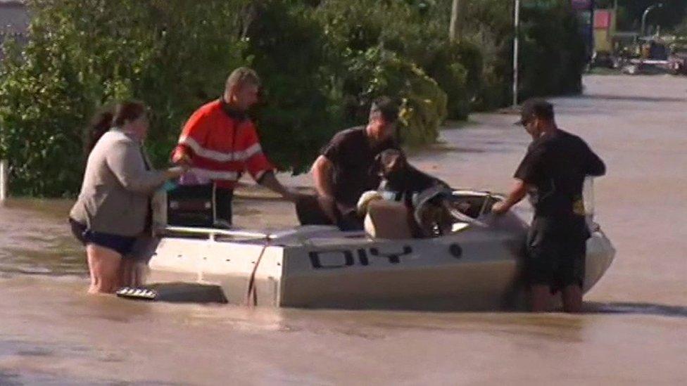 People being evacuated from floodwaters on a boat. Edgecumbe, New Zealand, 6 April 2017.