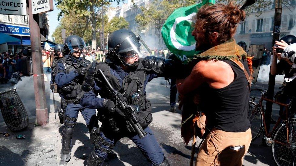 A police officer in a stand-off with a protester