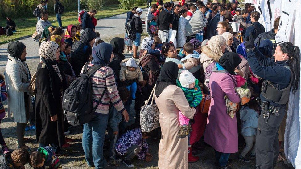 Refugees wait for medical examinations after their arrival at the railway station in Schoeneberg, in Berlin