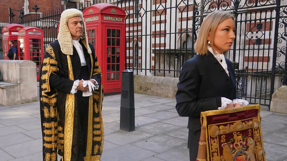 Brandon Lewis walks behind an official