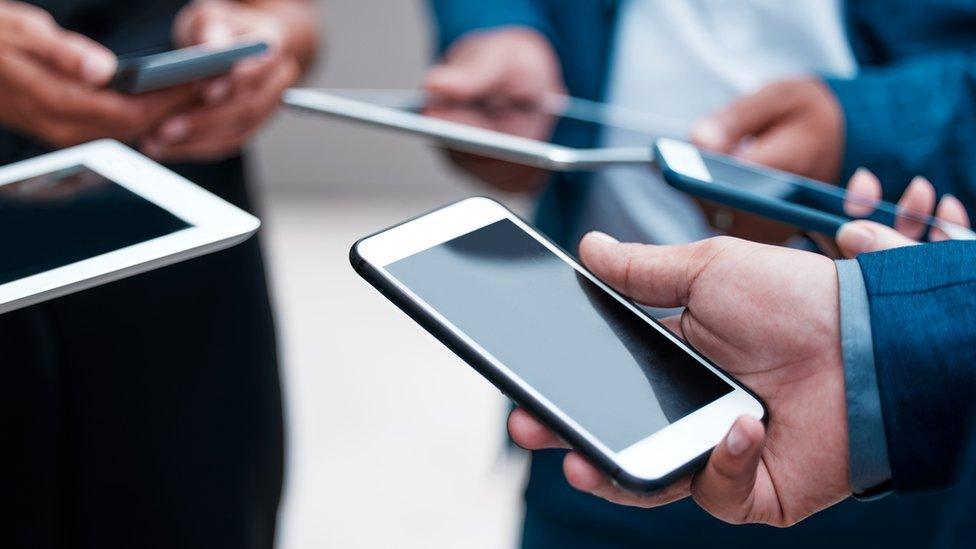 Stock image of people in suits holding phones