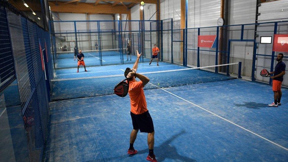 Four people playing padel