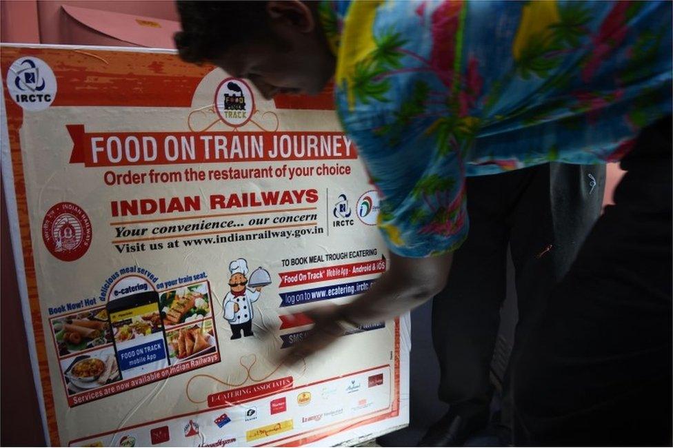 In this photograph taken on May 22, 2017, Indian staff prepare a food trolley onboard the Tejas Express luxury train during its first journey between Mumbai and Goa in Mumbai