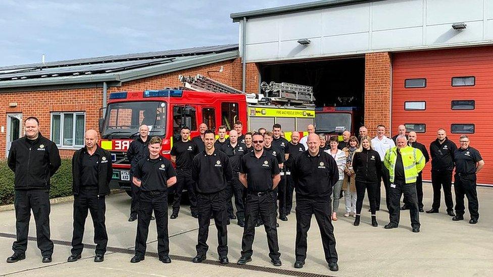 Members of Suffolk Fire and Rescue Service wave off their colleagues who are delivering fire engines to Ukraine