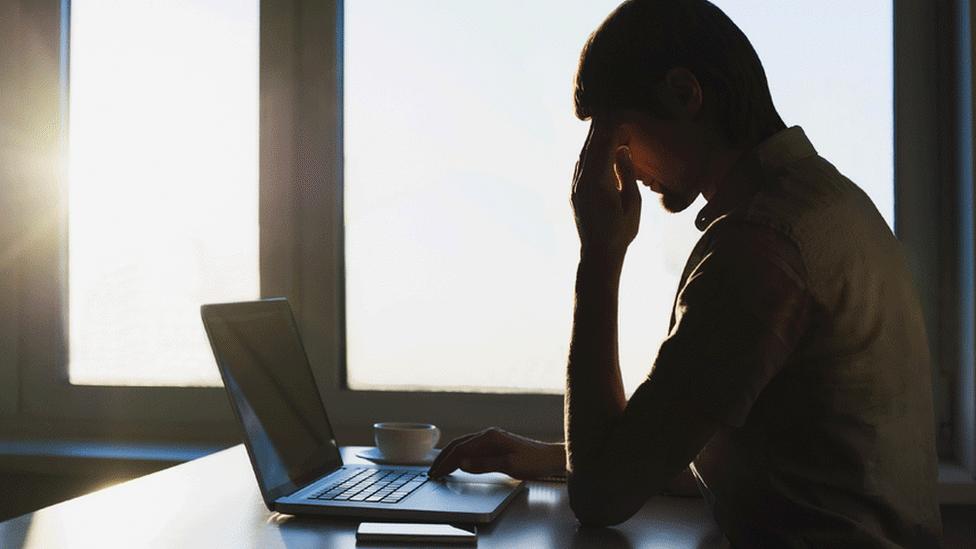 Man looking sad at computer