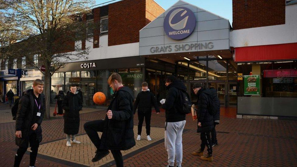 Boys playing football in Grays high street