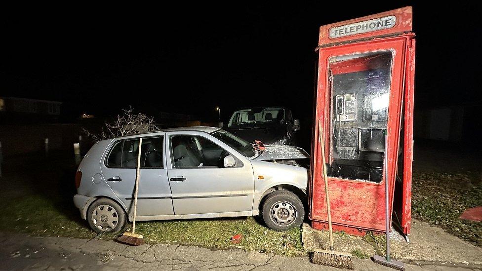 Car hitting a phone box