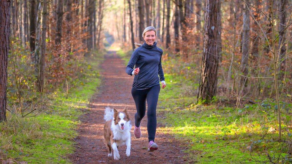 Woman running with a dog