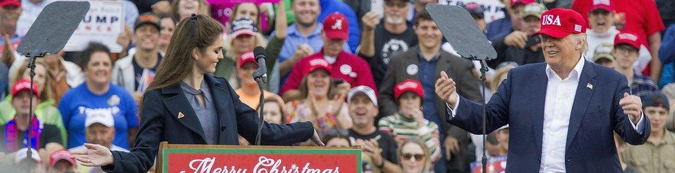 Press secretary Hope Hicks takes a bow for US President-elect Donald Trump after speaking during a 'Thank You Tour 2016' rally on December 17, 2016 in Mobile, Alabama. (