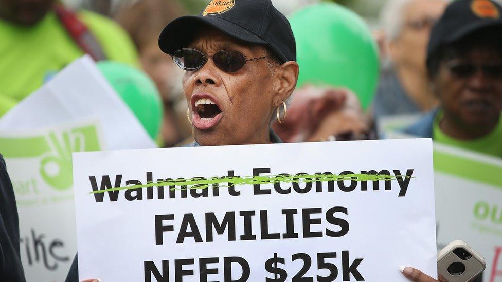 Wal-Mart workers and union activists protest outside a Wal-Mart store on June 4, 2014 in Chicago, Illinois. Workers and activists were scheduled to hold strikes at Wal-Mart stores in more than 20 cities today in their campaign to raise wages