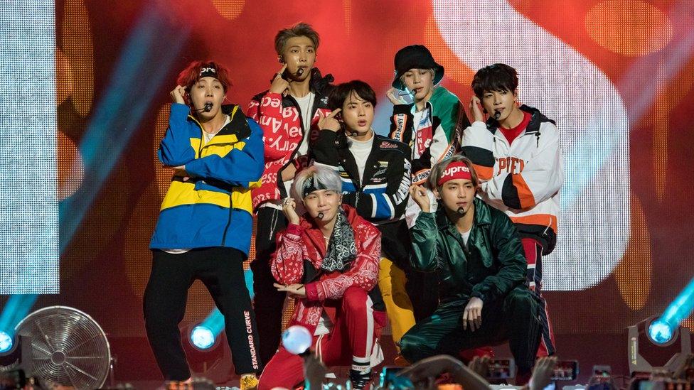 A group shot of the boy band BTS on stage