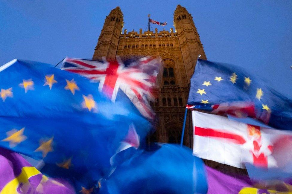 EU and union flags flying outside the Palace of Westminster