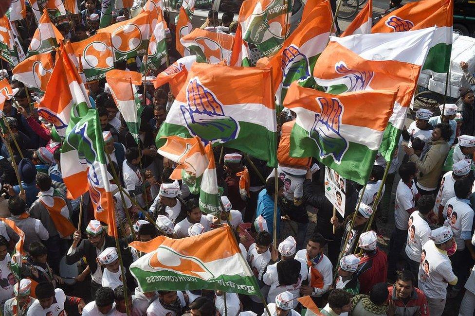 Congress party supporters wave party flags during an election roadshow with party vice-president Rahul Gandhi in New Delhi on February 4, 2015.