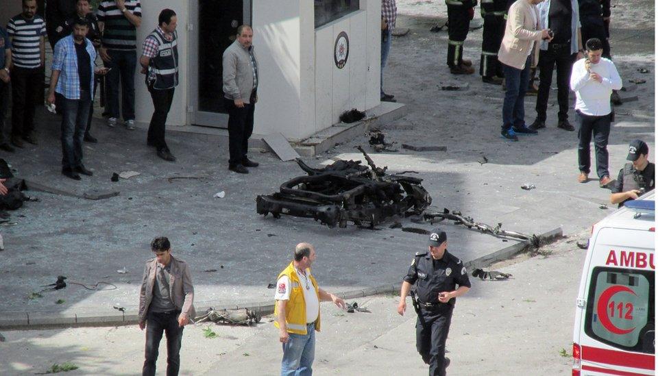 Security and forensic officials and medics investigate around the remains of a car after an explosion in Gaziantep (01/05/2016)