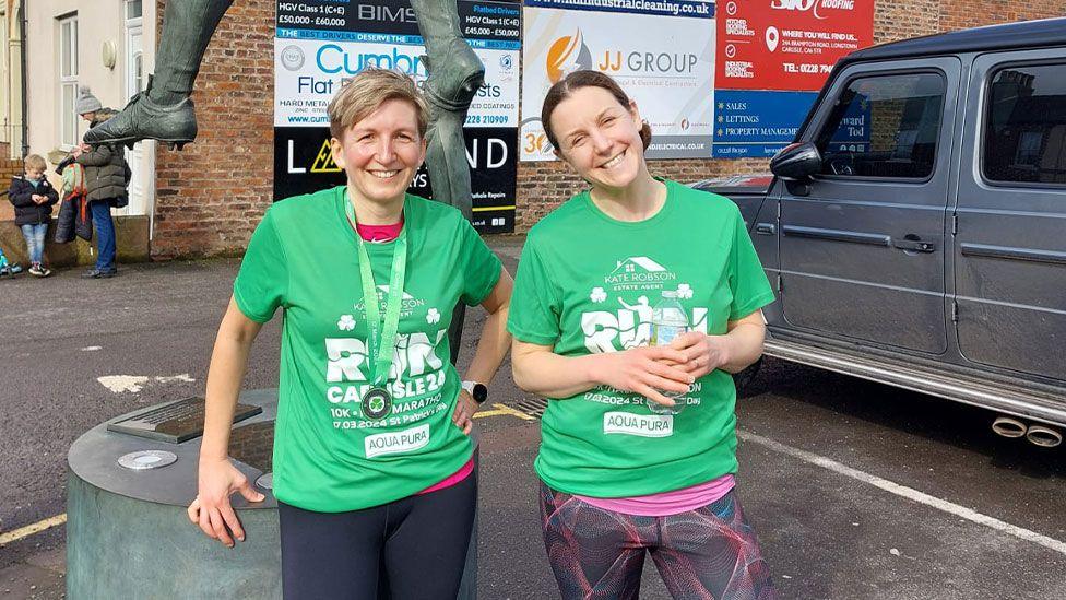 Nichola and sister outside Brunton Park in Carlisle, after completing 10K race

