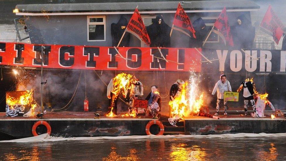 Joe Corre burns his £5 million punk collection on a boat on the River Thames in London.