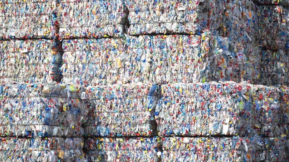 Bound bales of crushed plastic bottles and containers sit stacked ready to be recycled at a recycling center in the Netherlands.