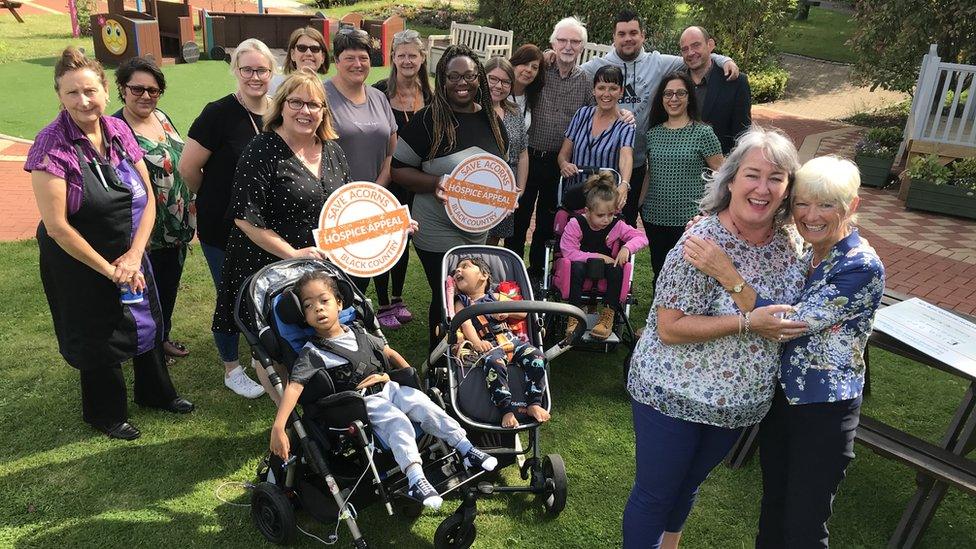 Erica (far right) with staff, volunteers and children at the hospice