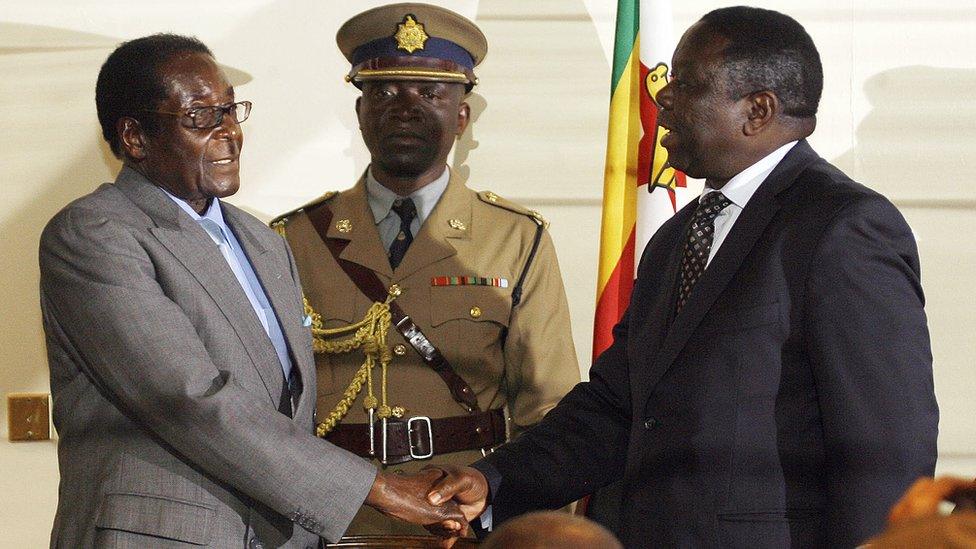 Mugabe and Tsvangirai shake hands in 2008