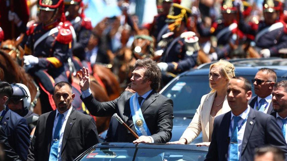 Javier Milei in a car as part of a procession