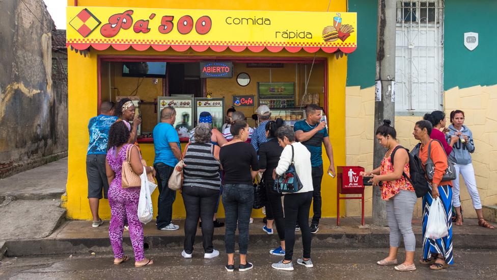 People queue at a private cafeteria close to the Old Hospital