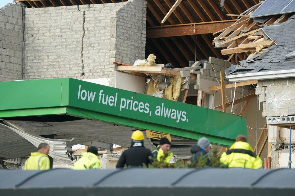 The damage caused to the service station and a nearby apartment block