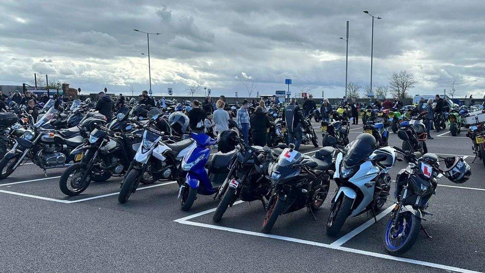 Motorbikes parked in a row in a car park