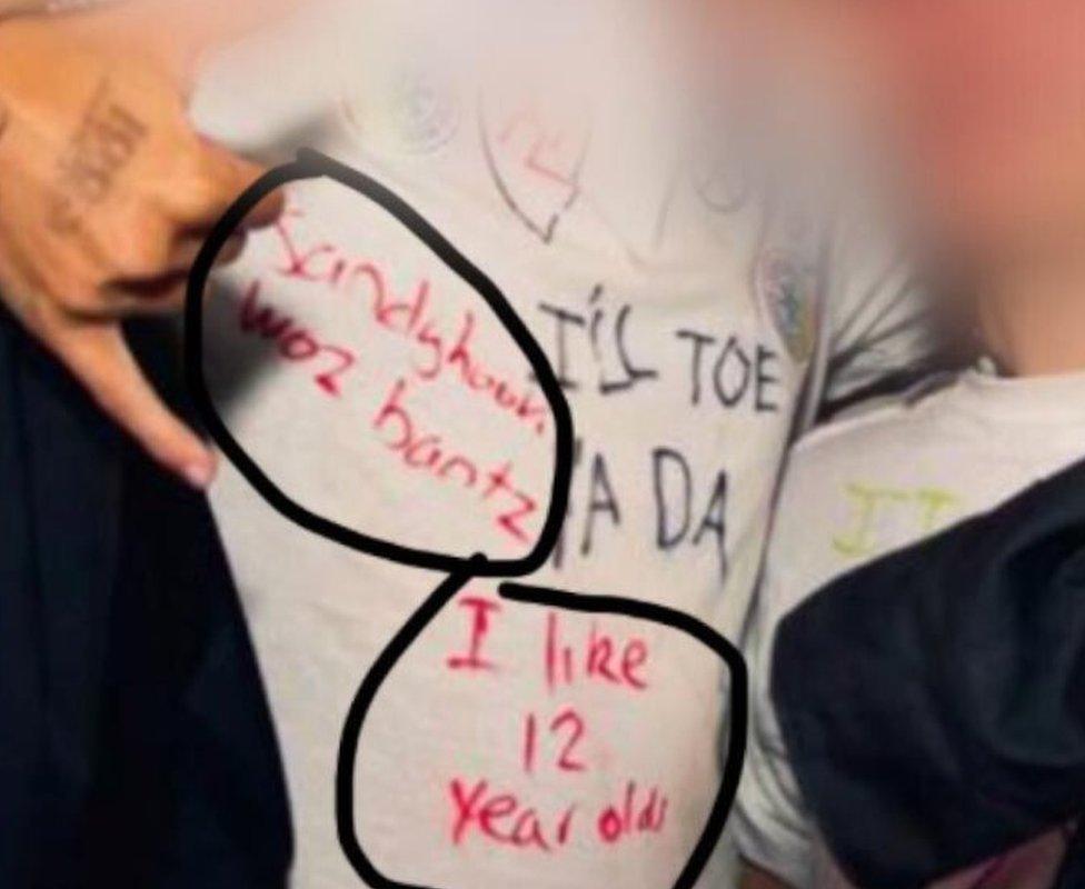 A photo showing a T-shirt with the slogan "Sandyhook woz bantz" and "I like 12 year olds"