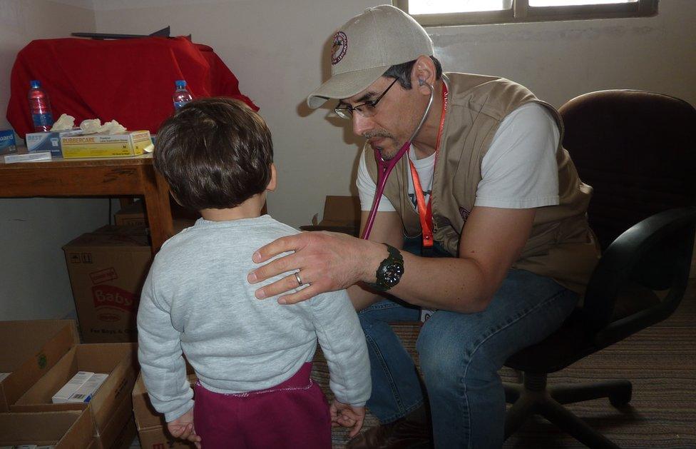 Jihad Shoshara examining unidentifiable patients on medical mission trips in Jordan for the Syrian American Medical Society