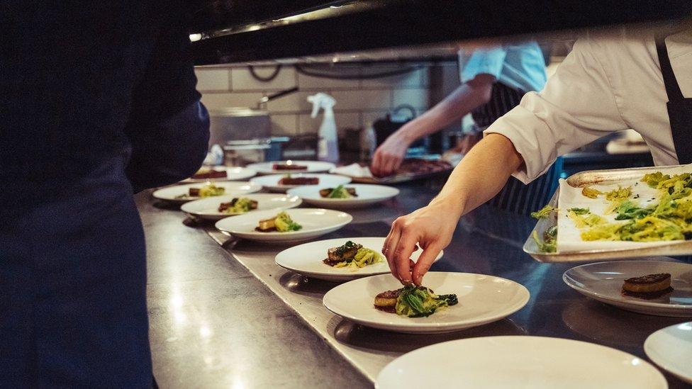 A closeup shot of chefs preparing food at a restaurant