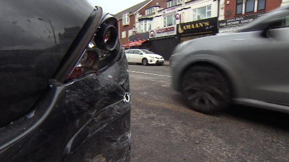 A damaged car on Soho Road