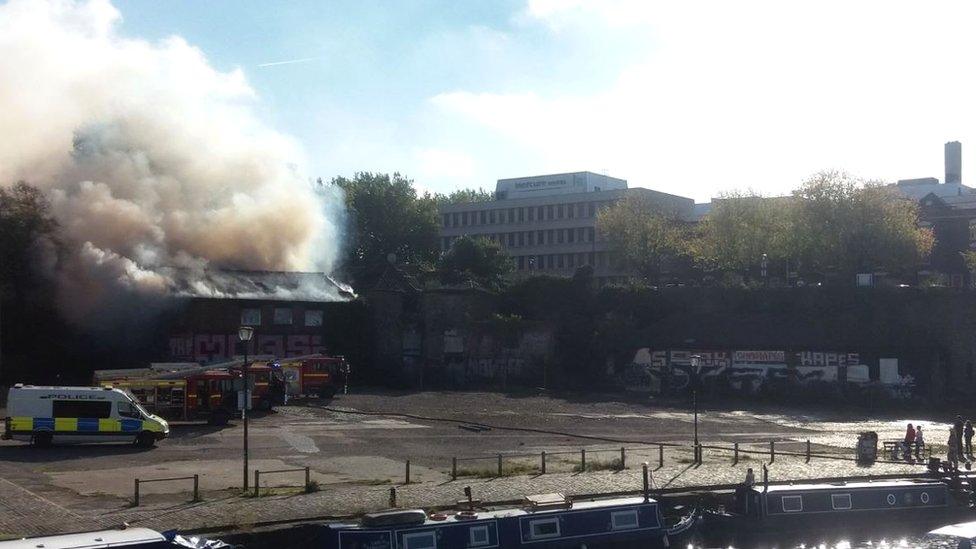 Derelict boat house on fire