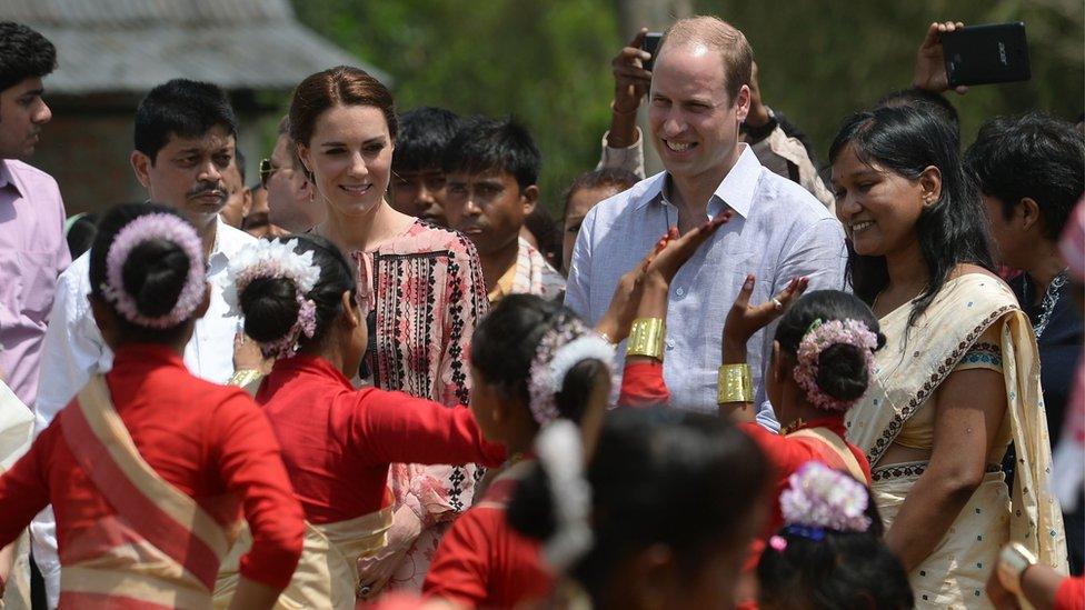 The Duke and Duchess of Cambridge watch villagers dance in Panbari Village, Assam, India, on 13 April 2016