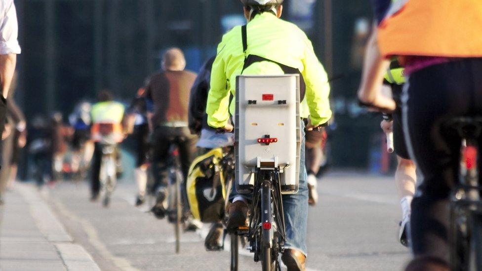 Cycling commuters on a busy road