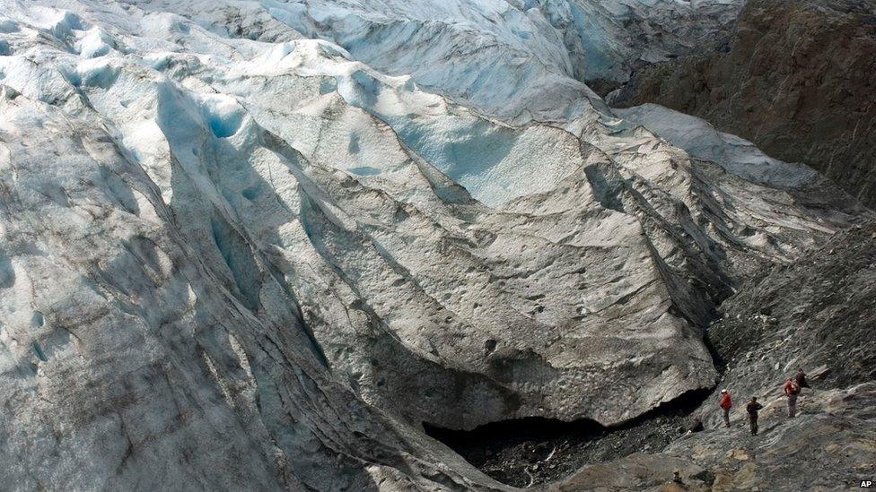 In this file photo taken Aug. 7, 2011, hikers get a close look at Exit Glacier near Seward, Alaska.