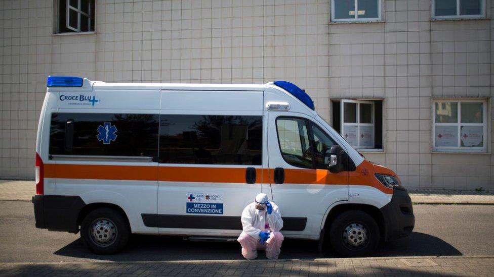 A health worker dressed in a protective suit outside a hospital in Rome