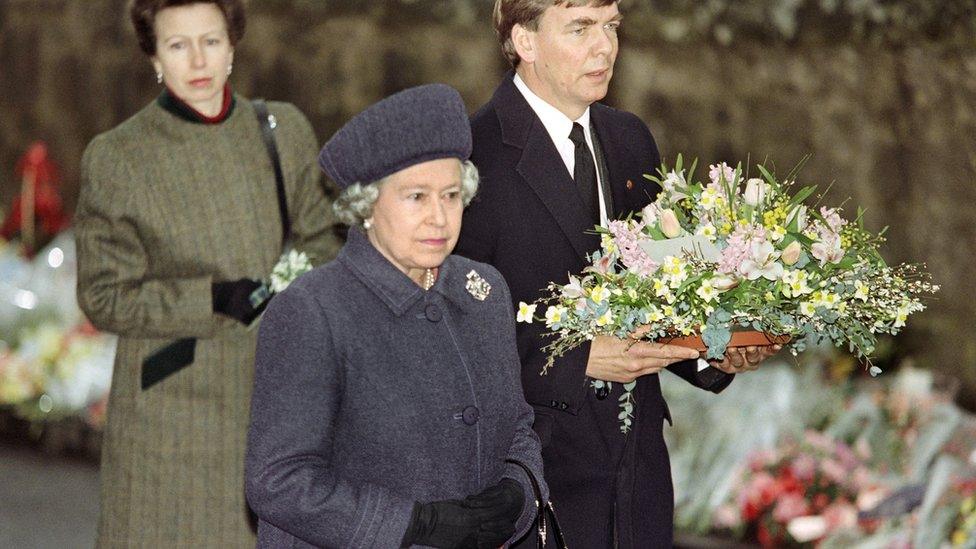 The Queen arrives with Princess Ann to lay a wreath at the entrance of Dunblane Primary School, where a gunman shot 16 children and a teacher in March 1996.