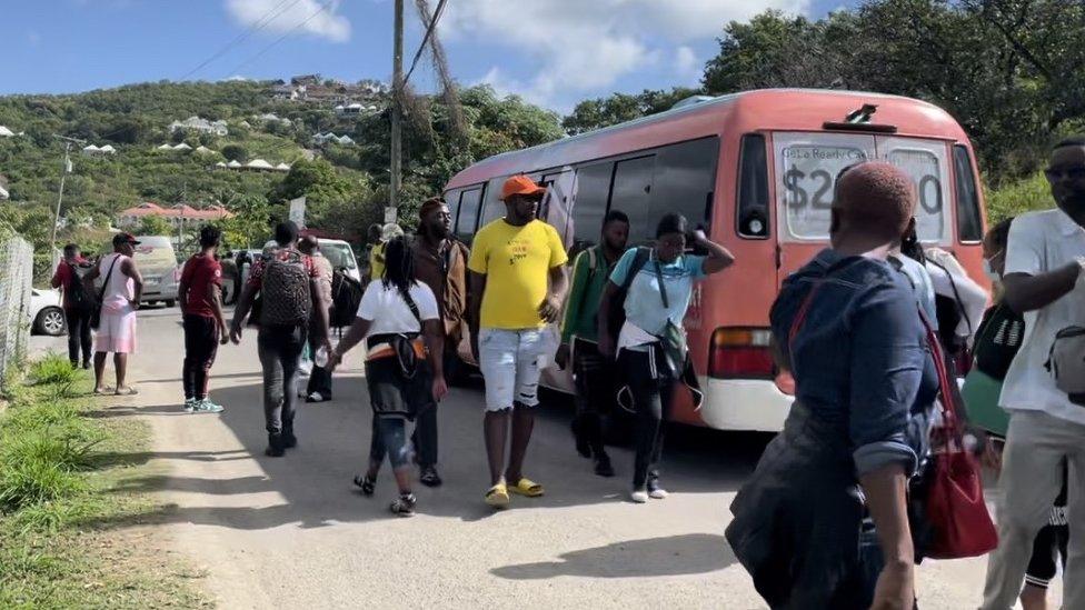 West African visitors - predominantly from Cameroon - shortly after arriving by charter flight on Christmas Eve trying to find accommodation in Antigua, December 2022