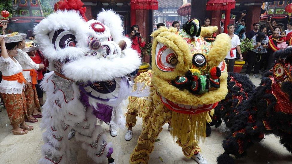 A group of dancers perform during Chinese Lunar New Year celebrations at a temple in Kuta, Bali, Indonesia