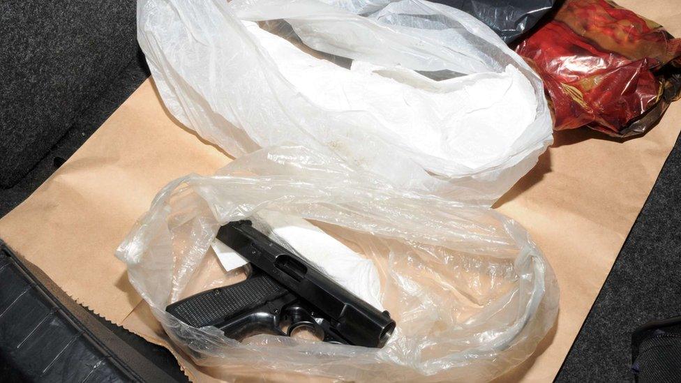 Handgun in plastic bag