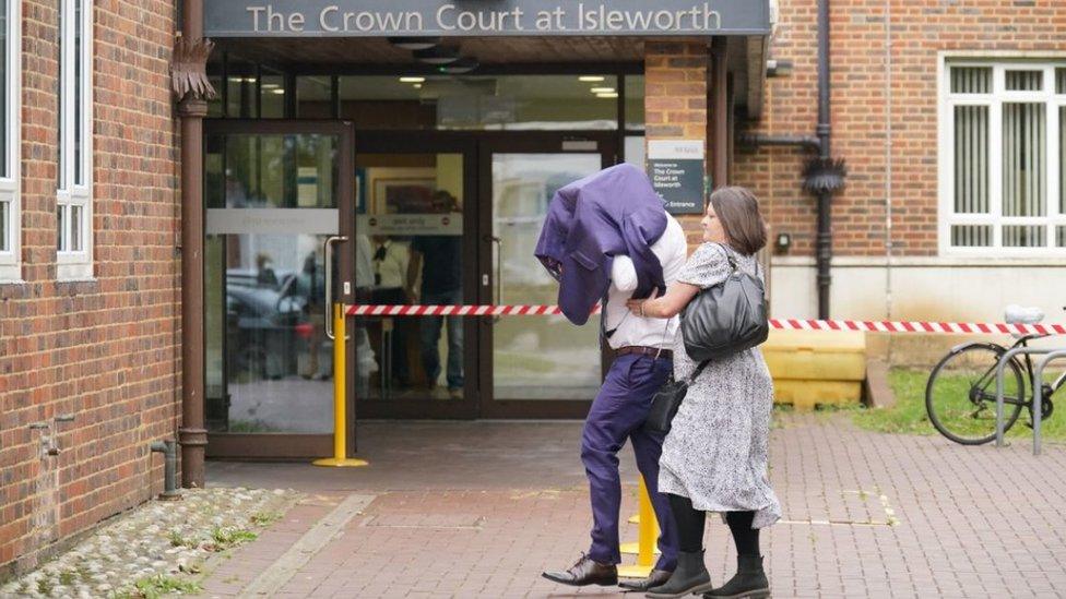 Lee Ryan arriving at Isleworth Crown Court on 28 September, with a jacket over his head.